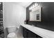 Modern bathroom with a sleek vanity and a custom framed mirror against a backdrop of custom paint at 6200 Bow Meadows Dr, Elizabeth, CO 80107