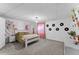 Bedroom with vinyl record decor, a giraffe plush, and a large window at 6200 Bow Meadows Dr, Elizabeth, CO 80107
