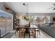 Well-lit dining room with modern lighting, a dining table, and outdoor views at 6200 Bow Meadows Dr, Elizabeth, CO 80107