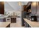 Open kitchen features stainless steel appliances, granite countertops, and dark wood cabinets at 6200 Bow Meadows Dr, Elizabeth, CO 80107