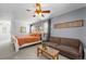 Spacious main bedroom offers a relaxing sitting area, ceiling fan, and lots of natural light through the window at 6200 Bow Meadows Dr, Elizabeth, CO 80107