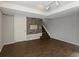 Open basement area featuring new hardwood floors, stylish stone accent wall, and a stairway at 5115 S Valdai St, Aurora, CO 80015