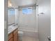 Standard full bathroom with shower-tub combination, tile surround, and bright natural light at 5115 S Valdai St, Aurora, CO 80015
