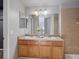 Bathroom featuring a double vanity, tiled walls, a large mirror, and neutral paint at 5115 S Valdai St, Aurora, CO 80015