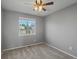 Standard bedroom featuring gray carpet, neutral paint, and natural light from large window at 5115 S Valdai St, Aurora, CO 80015