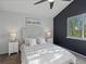 Serene bedroom with a large window, a statement wall, and well-coordinated furnishings at 5115 S Valdai St, Aurora, CO 80015