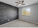 Standard bedroom featuring gray carpet, constelation accent wall, and natural lighting at 5115 S Valdai St, Aurora, CO 80015