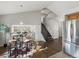 Eat-in kitchen features a stylish dining area, hardwood floors, and stainless steel refrigerator at 5115 S Valdai St, Aurora, CO 80015