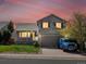 Charming two-story home with well-maintained lawn, two car garage, and inviting covered front porch at 5115 S Valdai St, Aurora, CO 80015