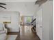 Bright hallway leading to kitchen with hardwood floors, and modern decor at 5115 S Valdai St, Aurora, CO 80015