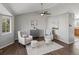 Cozy living room featuring vaulted ceilings, hardwood floors, a ceiling fan, and neutral decor at 5115 S Valdai St, Aurora, CO 80015