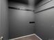 A minimalist walk-in closet featuring a closet rod for hanging clothing against gray walls at 5115 S Valdai St, Aurora, CO 80015