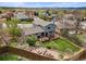 Aerial view of backyard with a fire pit and lush lawn at 705 Prairie Ridge Rd, Highlands Ranch, CO 80126