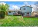 A backyard with a raised deck and lush green lawn at 705 Prairie Ridge Rd, Highlands Ranch, CO 80126