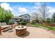 Outdoor patio with a stone fire pit, furniture, and a well-maintained lawn at 705 Prairie Ridge Rd, Highlands Ranch, CO 80126