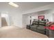 Finished basement space with gray leather sofa and neutral carpet at 705 Prairie Ridge Rd, Highlands Ranch, CO 80126