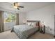 Cozy bedroom features a ceiling fan and a large window with natural light at 705 Prairie Ridge Rd, Highlands Ranch, CO 80126