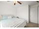 Bright bedroom with a ceiling fan, plush bedding, and white trim at 705 Prairie Ridge Rd, Highlands Ranch, CO 80126