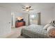 Spacious bedroom with ceiling fan, carpeted floors, and a large window at 705 Prairie Ridge Rd, Highlands Ranch, CO 80126