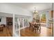 Open dining area with hardwood floors, a chandelier, and access to an outdoor deck at 705 Prairie Ridge Rd, Highlands Ranch, CO 80126