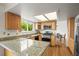Well-lit kitchen with granite countertops, stainless steel appliances, and light wood cabinets at 705 Prairie Ridge Rd, Highlands Ranch, CO 80126