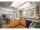 Bright kitchen with granite counters, stainless appliances, and access to a dining area at 705 Prairie Ridge Rd, Highlands Ranch, CO 80126