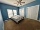 Blue bedroom with carpeted floors, fan, and dual closets at 7811 St Vrain Dr # 68, Frederick, CO 80530