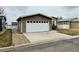 Attached two-car garage and well-kept front yard with charming single-story home at 7811 St Vrain Dr # 68, Frederick, CO 80530