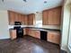 Well-lit kitchen featuring oak cabinetry, granite countertops, and modern black appliances at 7811 St Vrain Dr # 68, Frederick, CO 80530