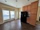 Well-lit kitchen featuring oak cabinetry, granite countertops, and modern black appliances at 7811 St Vrain Dr # 68, Frederick, CO 80530