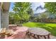 Lush backyard featuring a patio, mature trees, a picnic table, and a well-maintained lawn at 9661 Autumnwood Pl, Highlands Ranch, CO 80129