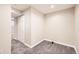 Cozy carpeted basement room featuring neutral paint, base trim, and closet for extra storage at 9661 Autumnwood Pl, Highlands Ranch, CO 80129