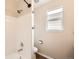 Bright bathroom featuring a tile shower, neutral walls, and a window for natural light at 9661 Autumnwood Pl, Highlands Ranch, CO 80129