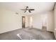 This spacious bedroom features a ceiling fan, neutral paint and carpeting, and multiple doorways at 9661 Autumnwood Pl, Highlands Ranch, CO 80129