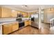 Well-equipped kitchen featuring stainless steel appliances and light oak cabinets at 9661 Autumnwood Pl, Highlands Ranch, CO 80129