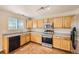 Well-lit kitchen with stainless steel appliances, ample cabinetry, and tile flooring at 9661 Autumnwood Pl, Highlands Ranch, CO 80129
