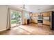 Bright kitchen and dining area with access to the backyard and stainless steel appliances at 9661 Autumnwood Pl, Highlands Ranch, CO 80129