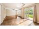Open-concept space with hardwood floors, large windows, and a sliding door to the backyard at 9661 Autumnwood Pl, Highlands Ranch, CO 80129