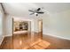 Bright living room featuring hardwood floors, neutral walls, and an open layout to the kitchen at 9661 Autumnwood Pl, Highlands Ranch, CO 80129