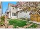 Scenic view of the back exterior featuring a lush lawn and a charming flowering tree at 540 E Fremont Pl, Centennial, CO 80122
