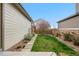 Neat backyard with a walkway, green lawn, and a charming flowering tree at 540 E Fremont Pl, Centennial, CO 80122