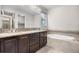 Elegant bathroom with dual sinks, a soaking tub, and stylish tile accents at 540 E Fremont Pl, Centennial, CO 80122