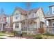 Attractive two-story home with a quaint front porch, small bench, and blooming landscape, offering charm and comfort at 540 E Fremont Pl, Centennial, CO 80122