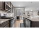 Modern kitchen boasts stainless steel appliances, granite countertops, and seamless access to the outdoor patio at 540 E Fremont Pl, Centennial, CO 80122