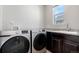Convenient laundry room with modern washer and dryer, ample counter space, and a bright window at 540 E Fremont Pl, Centennial, CO 80122