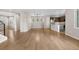 Open-concept living space with hardwood floors, staircase, kitchen, and abundant natural light at 540 E Fremont Pl, Centennial, CO 80122