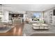 Open-concept living room and kitchen area with hardwood floors and bar seating at 540 E Fremont Pl, Centennial, CO 80122