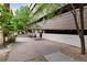 Exterior street view showing a garage adjacent to a sidewalk with green trees at 7240 W Custer Ave # 303, Lakewood, CO 80226