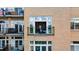 Close-up of balcony with railing and plants outside window and a peek inside at 7240 W Custer Ave # 303, Lakewood, CO 80226