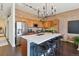 Kitchen featuring a large island with seating, stainless steel appliances, and modern lighting at 7240 W Custer Ave # 303, Lakewood, CO 80226
